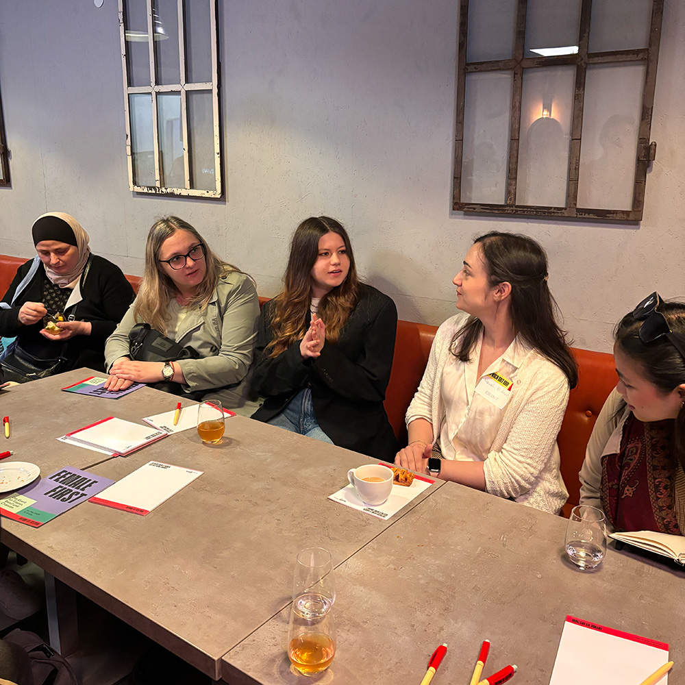 Women in conversation sitting at a table
